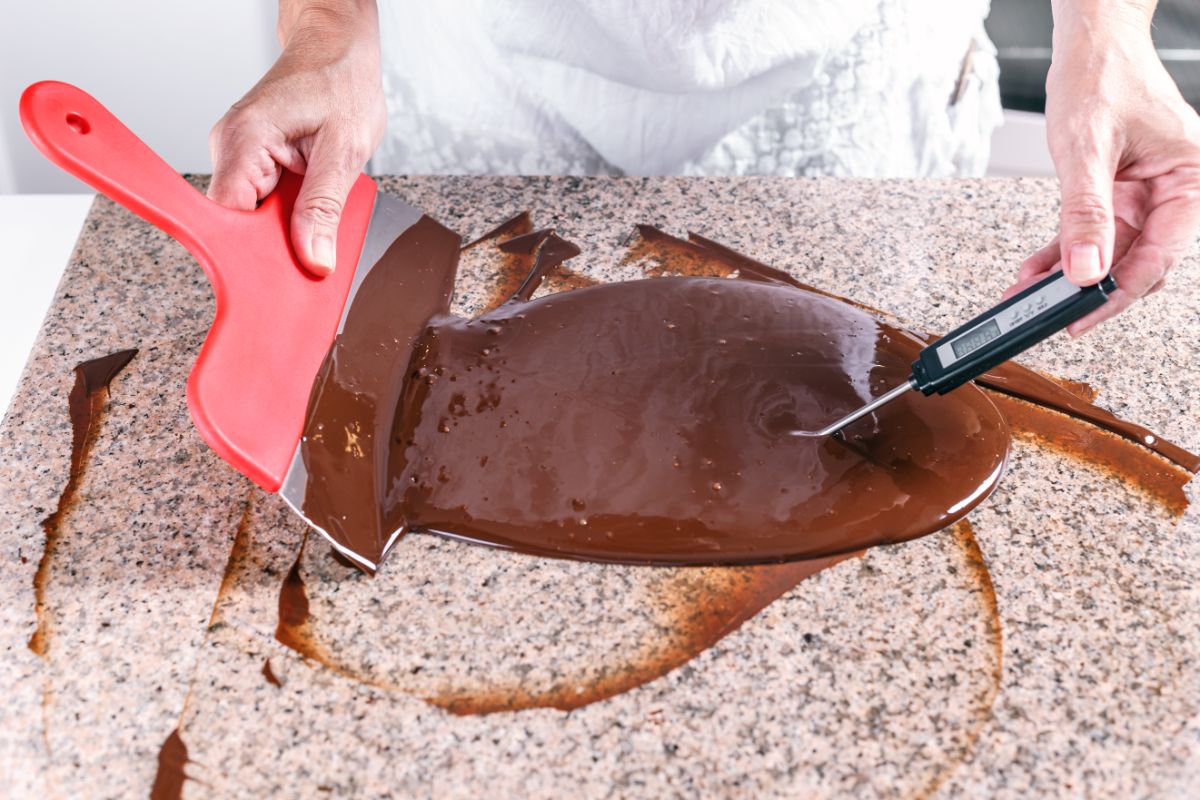 Chocolate being tempered on a marble slab.