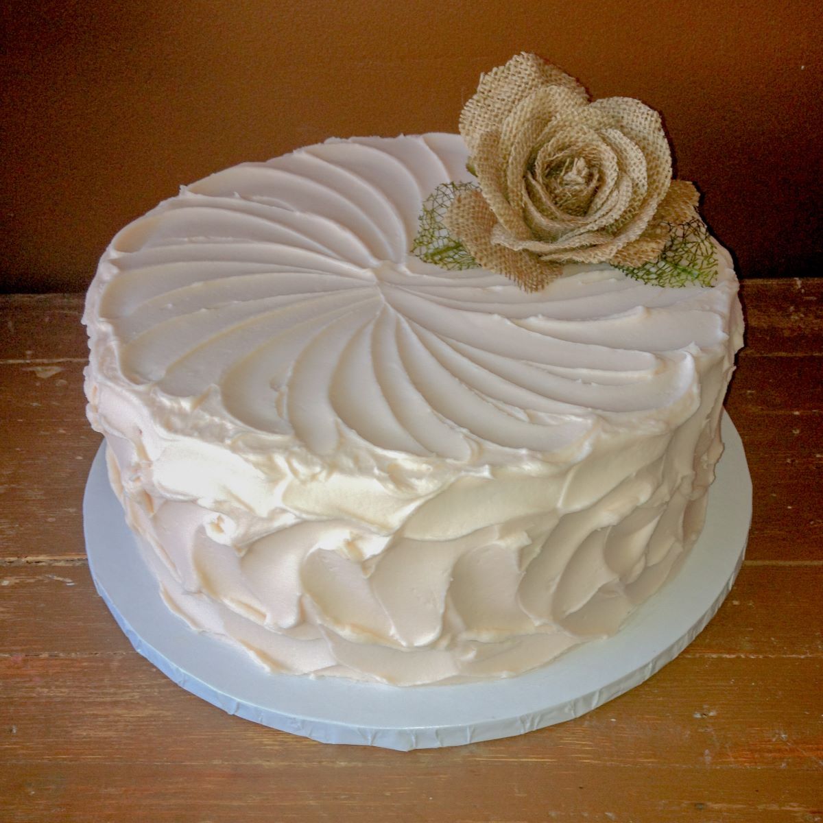 A cake with a simple white textured frosting.